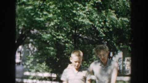 WISCONSIN USA-1957: Ladyboy Walking Neighborhood Trees Kid Strolling Tall Grass Water