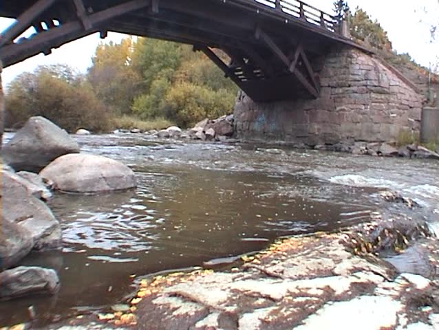 Bridge on the river with waterfalls
