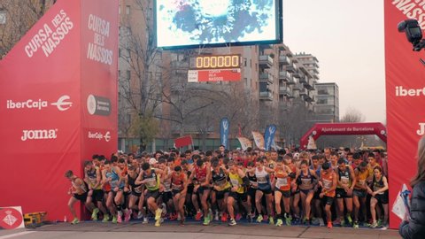 BARCELONA, SPAIN, 31 DECEMBER 2019: Marathon start, running people new year challenge, crowd of people start run