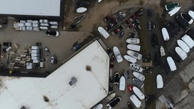 Fast Moving Aerial Over Boat Dealership With Boats For Sale In Springtime