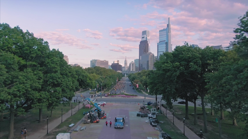 Aerial flying over Fairmount Park, Benjamin Franklin Parkway to the city skyline at sunset. Philadelphia, Pennsylvania, USA. 