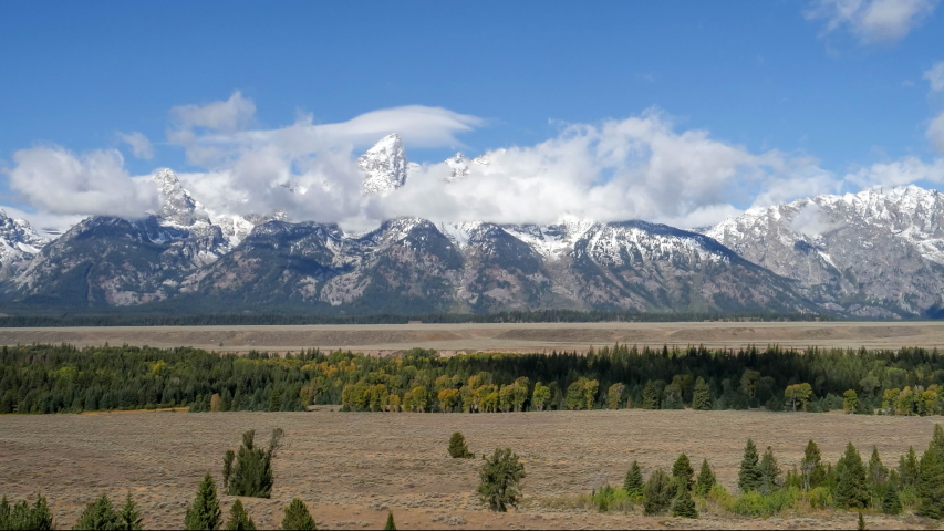 time lapse of storm clouds clearing from teton mountain range at grand teton national park in wyoming, usa