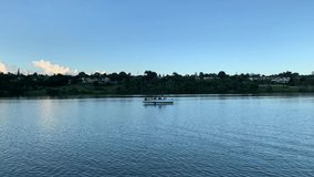 Brasília, Brazil, January 20, 2020: Video of a motorboat on Lake Paranoa. Incredible view with leisure and water sports options. In the background a forest and a condominium with houses