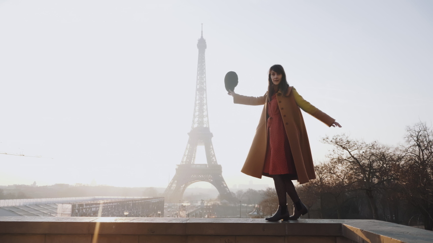 Side view beautiful happy woman doing fun dance walk at romantic sunset Eiffel Tower sky panorama in Paris slow motion. Royalty-Free Stock Footage #1044540508