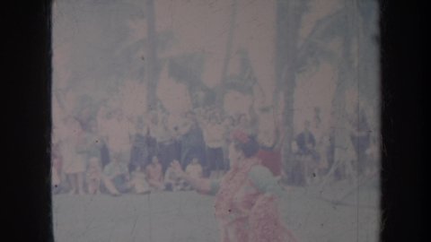 HONOLULU HAWAII USA-1967: People Watching Women Performing Dancing And Man Dressed Like Santa Claus Dancing