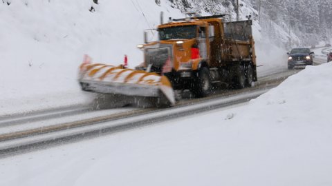 Snow Plow On Highway During Winter Storm