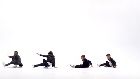 Kids are dancing a modern dance on the white background in black leather jackets and jeans. Slow motion