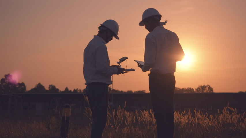 Technician and investor Using Infrared Drone Technology to Inspect Solar Panels and Wind Turbines in Solar cell Farm, Solar cells will be an important renewable energy of the future. Royalty-Free Stock Footage #1044566755