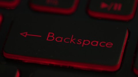 clicking finger pressing backspace button on keyboard computer