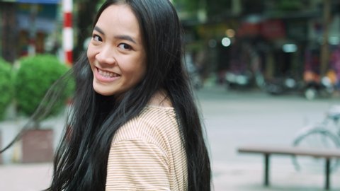 Handheld video of beautiful Vietnamese woman in the city street