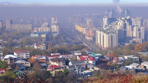 Almaty, Kazakhstan – November, 2019: excessive smoke and gas pollution due to an increase in the number of vehicles and increased industrial emissions in Almaty city, Kazakhstan. Time lapse zoom in