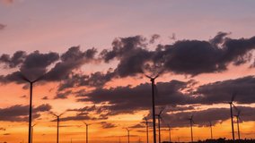 Timelapse 4k of Wind turbines of save Energy save world in video 4k format. wind turbines at sunrise and sunset with beautiful clouds. footage b-roll scene 4k.