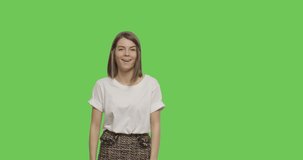 Happy smiling young pretty woman showing emotions by face and having fun/ Isolated on Green Screen, Chroma Key. 4k raw video footage slow motion 60 fps