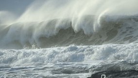 Extreme Ocean Wave crushing coast. Power of waves breaking splashing sea-spray water foam 
