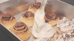 cinnamon rolls covered with cream close up 4K video.