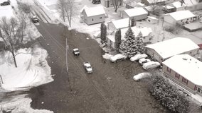 Winter flooding of neighborhood, streets filled with ice water, aerial drone view.
