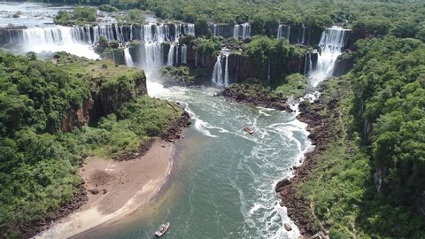 Flowing, Falls. Aerial landscape of Cataratas do Iguaçu Waterfall, a tourism point of Foz do Iguaçu, Brazil and of Misiones, Argentina. Great landscape. Elected one of the seven wonders of the world. 