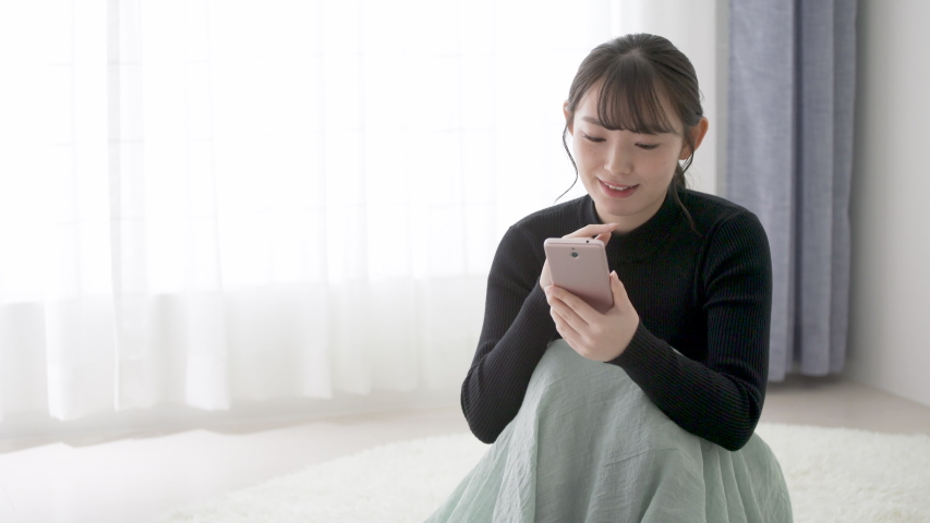 A woman operating a smartphone