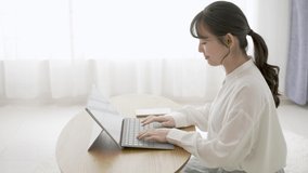 Woman operating a laptop image