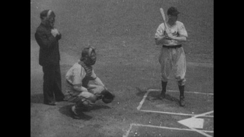 1940s: Batter, referee and catcher at home plate. Batter swings. Catcher throws ball. Caption reads "CLYDE McCULLOUGH." Catcher signals to pitcher.