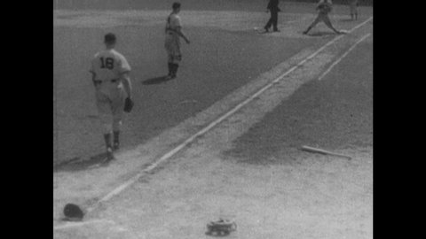 1940s: Catcher puts on mask. Baseball game. Captions read "WALKER COOPER," "MORT COOPER," and "RAY MUELLER." Man throws ball. Catcher catches ball and tags home plate. Catcher signals pitcher.