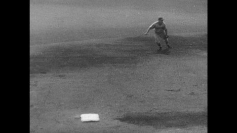 1940s: Baseball game. Men throw ball and tag base. Men slide.