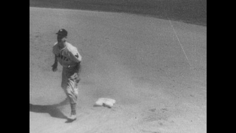 1940s: Baseball game. Players move on field. Caption reads "FRANKIE GUSTINE." Man tags base and throws ball. Player slides.