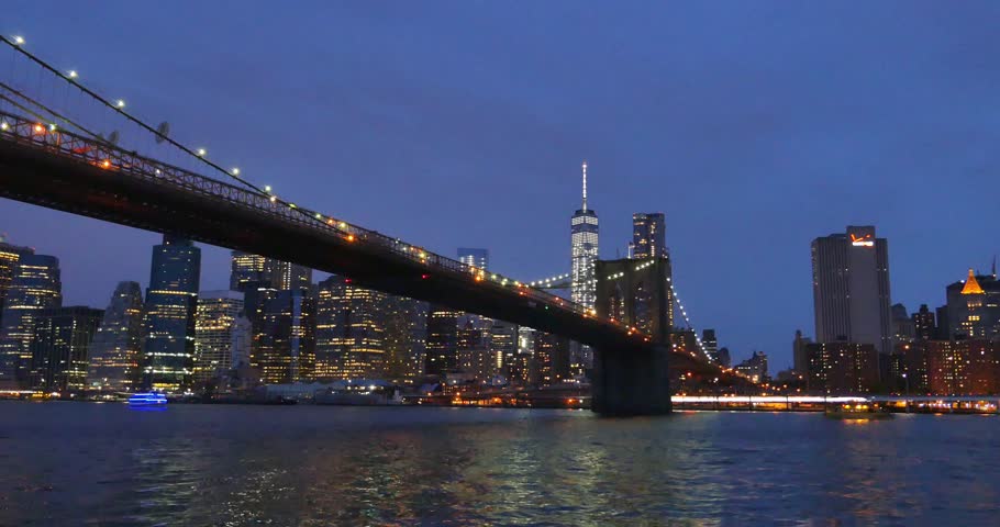 NEW YORK CITY - Circa June, 2015 - An evening establishing shot of the Brooklyn Bridge over the East River with lower Manhattan in the background. | Shutterstock HD Video #10446389