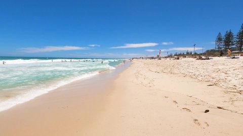PERTH, WESTERN AUSTRALIA - December 27th, 2019: slow motion walking on  Scarborough beach near Perth on a sunny and warm summer day near the water
