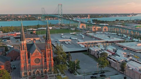 Aerial flying over U.S. Customs and Border Protection for freight trucks crossing the Ambassador bridge & Ste. Anne de Detroit Catholic Church. Detroit, Michigan, USA. 19 September 2019