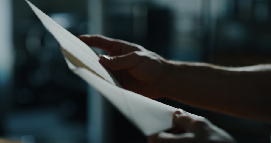 Cinematic close up shot of man is putting a letter in an envelope before sending it. Concept of correspondence, calligraphy, communication Royalty-Free Stock Footage #1044648064