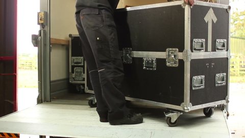Roadie / Crew loading Flightcases into the Truck after a Gig - The Stage Hand is packing the equipment away from the venue.