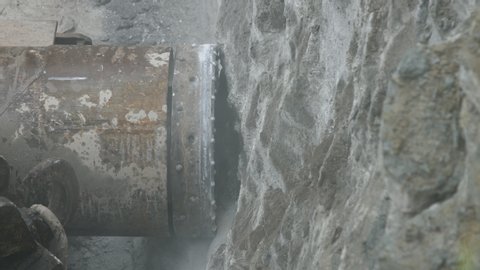 Horizontal drilling rig cutting utilities tunnel hole into limestone rock