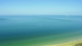 Drone footage of a boat passing over the water. (Cap Blanc Nez Beach, France)