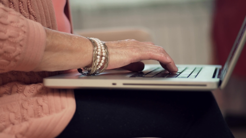 Senior Woman Hands Typing On Laptop Keyboard.Mature Woman Using Computer Browsing Social Networks In Internet.Elderly Hands Typing On Notebook Keyboard And Writing Message.Senior Woman Surfing Browser | Shutterstock HD Video #1044660274