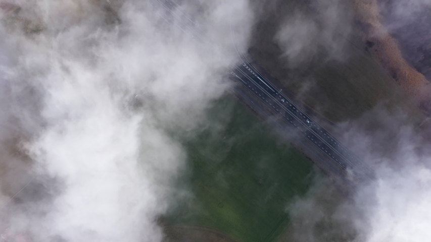 Above clouds fields and road highway in France Auvergne 