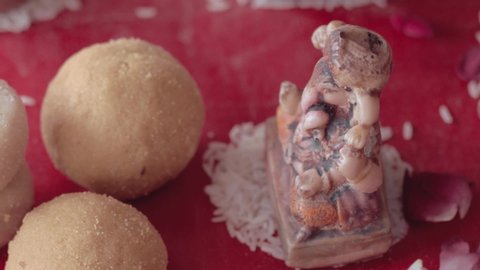 Close shot of the Deity beside laddu during the puja in a Hindu wedding ceremony 