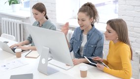 Attractive Female Designers doing Video Chat on Computer 