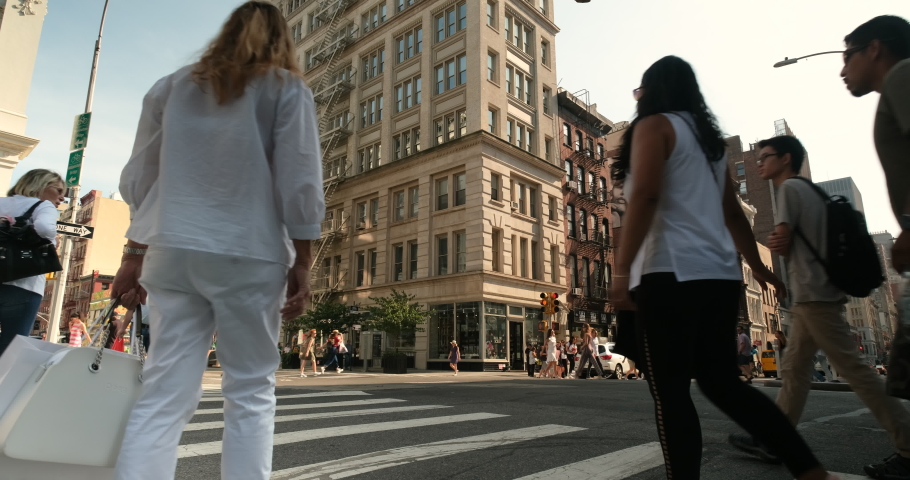 Manhattan, New York - September 22, 2019: People walk along the fashion stores and trendy restaurants onBroadway and Spring Street in the downtown Soho district of Midtown Manhattan New York City 