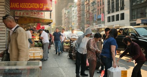 Manhattan, New York - September 18, 2019: People walk along the densely populated neighbourhood streets of downtown Chinatown in Manhattan New York USA.