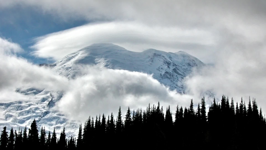 Mount Rainier, also known as Tahoma or Tacoma, is a large active stratovolcano in Cascadia located in Mount Rainier National Park. fantasy clouds cinemagraph, loopable