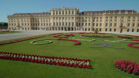 VIENNA AUSTRIA - JULY 11. 2019 Segway driving shot of Schönbrunn Palace / Schonbrunn Palace, moving along baroque gardens, near Schonbrunn Palace building, blue sky, people walking along, no sound