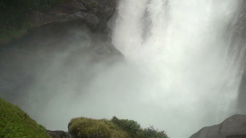 View of Krimml Waterfall with powerful stream of water falling down with a splash. Slow Motion Footage