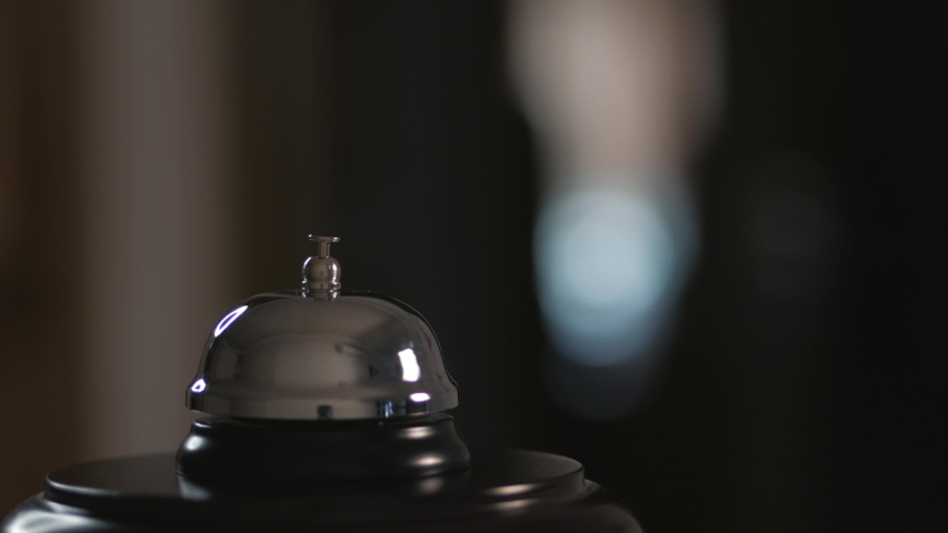 Close-up of a call to the front Desk of the hotel. Men finger presses the bell. Royalty-Free Stock Footage #1044712477