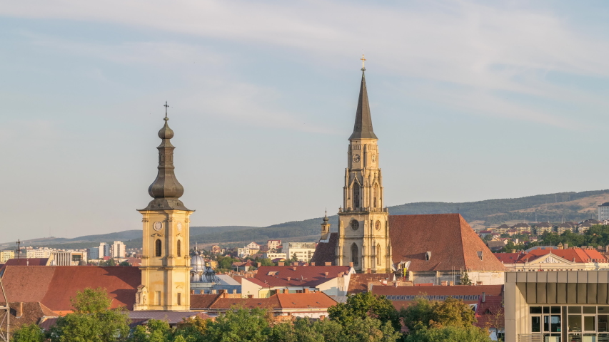 Cluj-Napoca, Romania: Day to night timelapse of the iconic Romano - Catholic Church Saint Michael and Franciscan Temple. Cluj-Napoca landmarks timelapse, Romania. Cluj time lapse