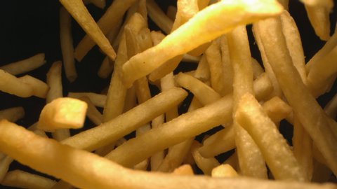 French Fries or Chips Floating in the Air Flying in Slow Motion on Black Background at 1500 fps 4K