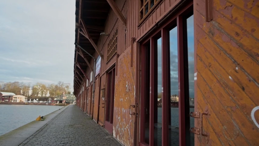 Historic wooden storage sheds with reflections in the windows on the quay on the river Trave in the port of Luebeck, Germany
