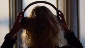 Slow Motion Of Young Woman Putting On Headphones - Powered by Shutterstock - Get 15% off with code: PIKWIZARD15