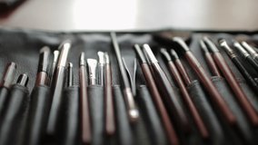 Set of brushes for makeup on table in the beauty salon. Fashion industry.