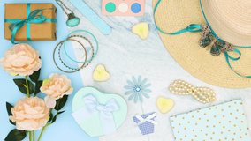 Feminine blue pastel stylish and trendy accessories moving on blue background - Stop motion 